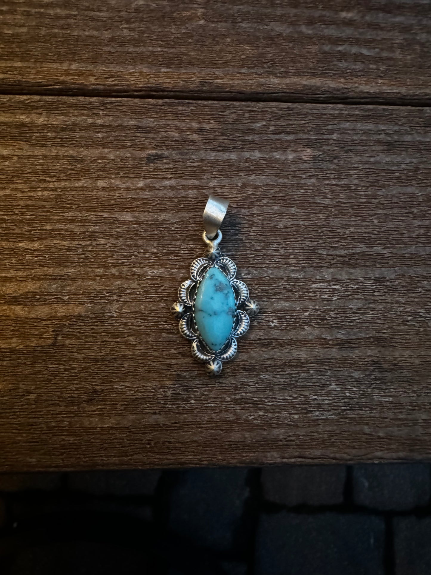 Turquoise pendant with silverwork
