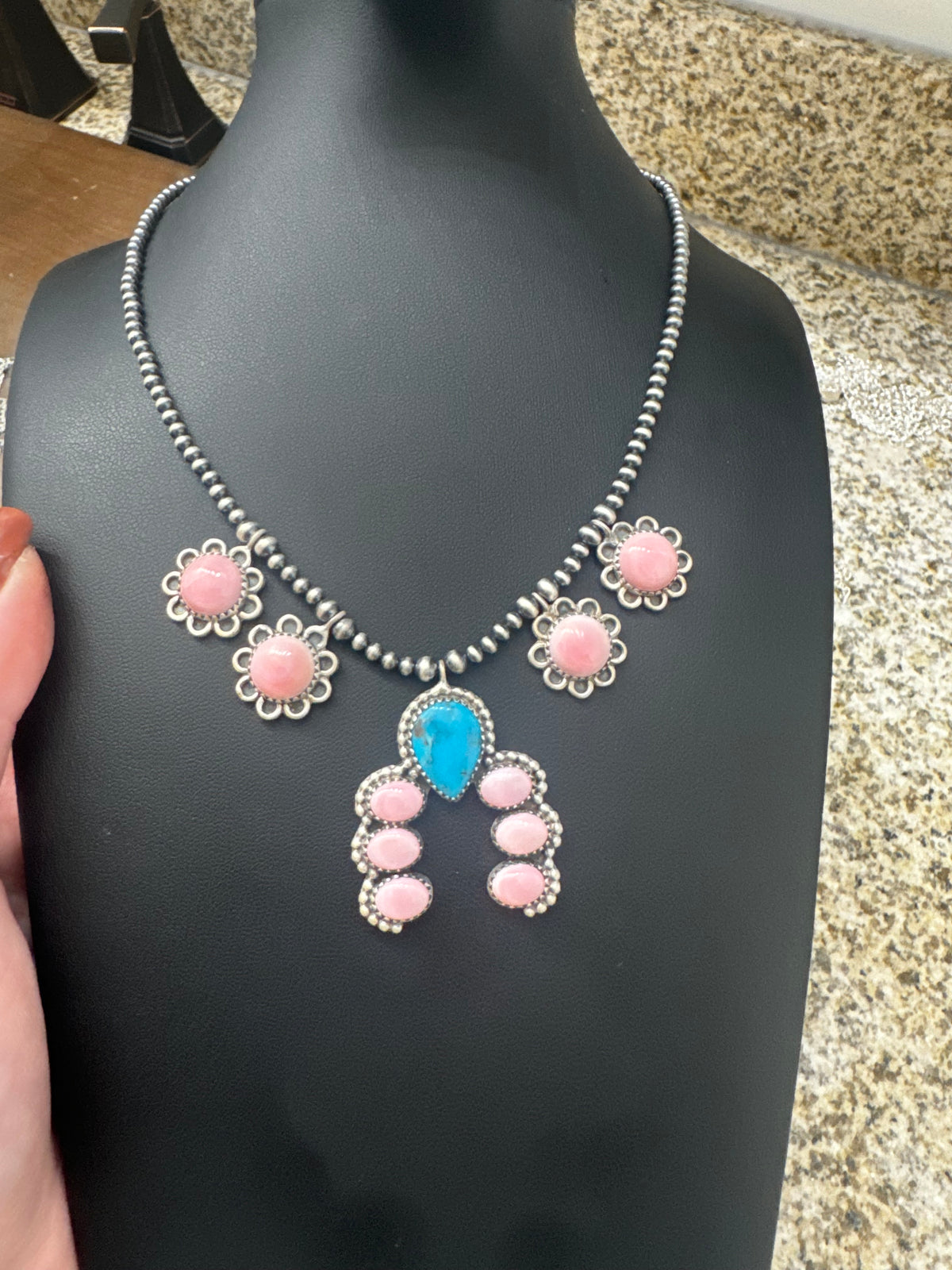 Pink conch and turquoise necklace on pearls