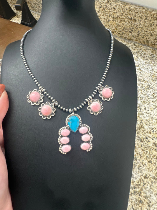Pink conch and turquoise necklace on pearls